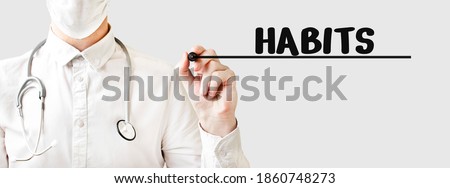Doctor writing word HABITS with marker, Medical concept