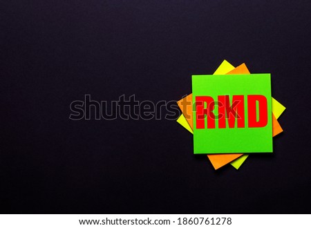 The word RMD on a bright sticker on a dark background