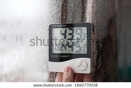 Humidity indicator is indicated on the hygrometer of the device. An image of electronic device to check temperature and humidity in closed area Royalty-Free Stock Photo #1860770038