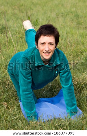 Woman doing pilates in the park 