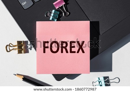 The FOREX Note is written on a paper sticker on your laptop keyboard.