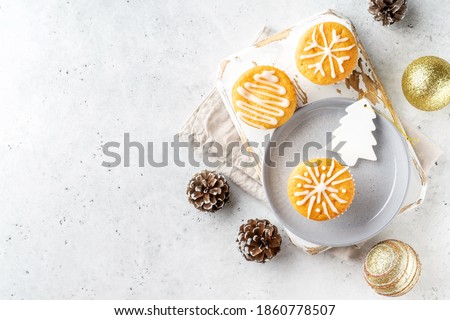Christmas or New Year homemade mini cake with icing sugar. White stone table background. Festive decoration. Flat lay, top view, copy space.