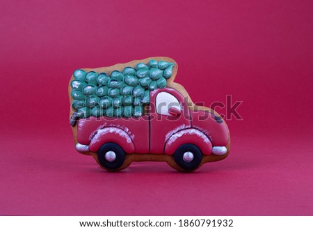 gingerbread car with a Christmas tree on a red velvet background. Christmas gingerbread cookies