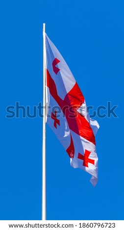 Georgia national flag waving in the wind on a blue sky