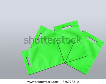 Assorted Color Bags D-Cut Type Non Woven Fabric on Background. Die Cut Gift Bags, Reduce, Reuse, Recycle. Use Me I am not Plastic. ECO Friendly Environment Concoct.  