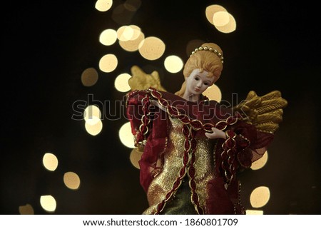 Christmas angel ornament on lights background.