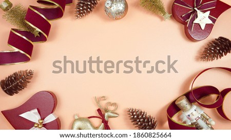 Luxury Christmas background with on trend fashionable stylish coral, deep red and gold gifts and decorations. Top view blog hero header creative composition flat lay with negative copy space.