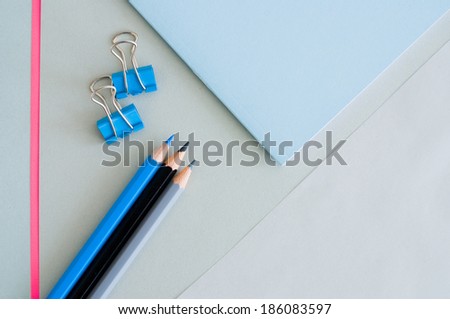 pencils on graphic background - desktop from above - top view -
trend color - rose quartz and serenity pastel tones