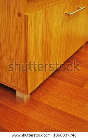 Walnut cabinet and corner detail on mahogany parquet in a luxury house