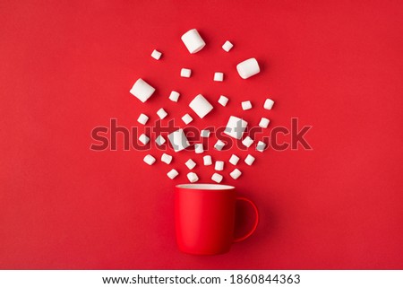 Close up top view photo picture of coffee cup and splashing white marshmallow isolated bright color red background