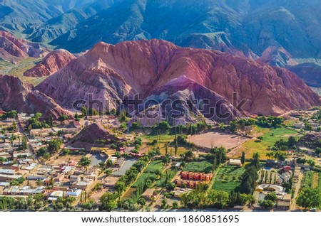 Stock photo of houses from the village of Purmamarca in Jujuy, Argentina. Landscape with colored mountains and hills Royalty-Free Stock Photo #1860851695