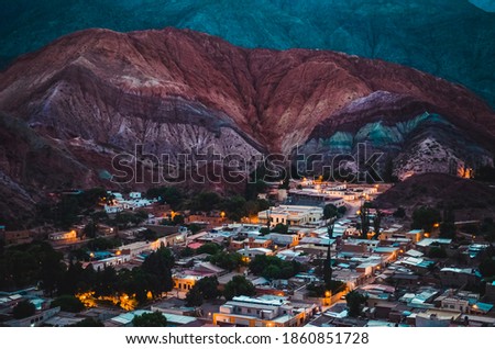 Stock photo of houses from the village of Purmamarca in Jujuy, Argentina. Landscape with colored mountains and hills in nightfall Royalty-Free Stock Photo #1860851728