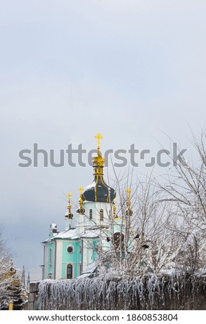 Winter landscape - Orthodox church in the snow among trees on a cold frosty day