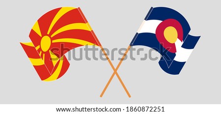 Crossed and waving flags of The State of Colorado and North Macedonia