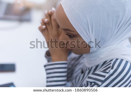 African muslim  businesswoman feeling unwell suffering from headache migraine touching forehead during work, upset black woman employee frustrated by business problem or work stress, head shot