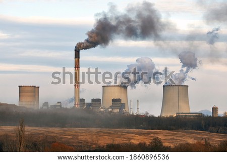Power plant emiting dark thick smoke and steam. Matrai eromu, Mátrai Erőmű, Visonta, Hungary Royalty-Free Stock Photo #1860896536