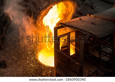 Tank pours liquid metal at the steel mill Royalty-Free Stock Photo #1860900340