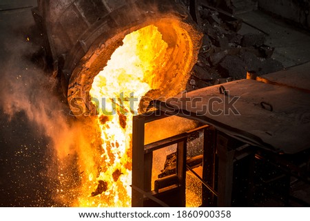 Tank pours liquid metal at the steel mill Royalty-Free Stock Photo #1860900358
