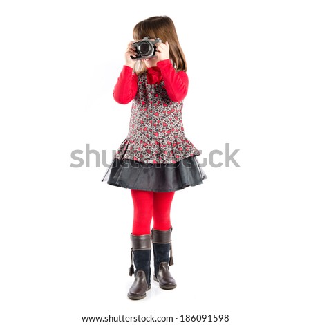 Girl taking a picture over white background 