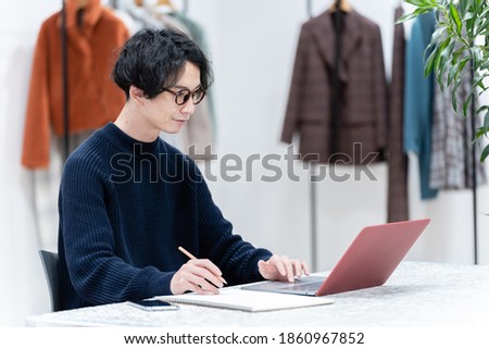 young male fashion designer working at office