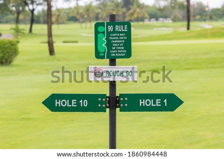 Signs for the tee off at the golf course, hole 1 and hole 10 with flower nature background