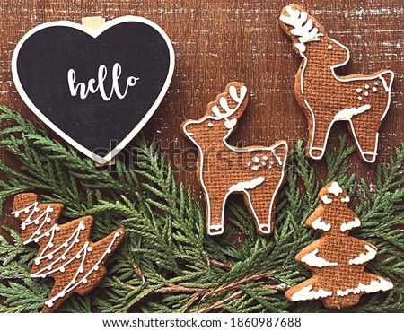Christmas cute wallpaper with heart chalkboard and homemade gingerbread cookies on wooden table