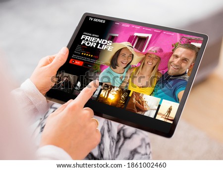 Person using video streaming app on tablet and browsing movies and TV series to watch Royalty-Free Stock Photo #1861002460