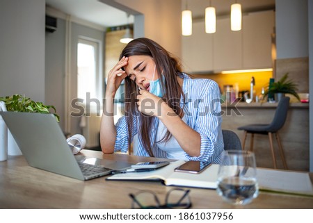 Business woman in mask sitting at desk feels unhealthy put hand where is lungs, suffering from repeated coughing and breath difficulties. Risk coronavirus 2019-ncov contamination 
