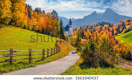 Iconic picture of Bavaria with Maria Gern church with Hochkalter peak on background. Sunny autumn scene of Alps. Beautiful landscape of Germany countryside. Beautiful autumn scenery.