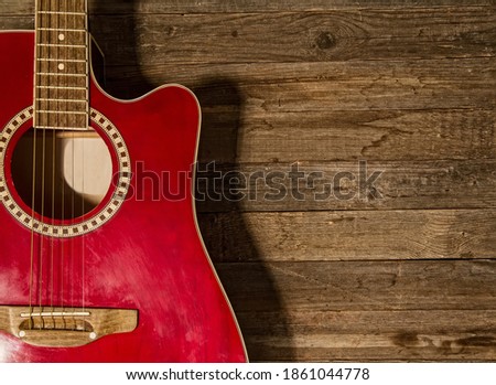 Beautiful old classical acoustic guitar close-up on a wooden background