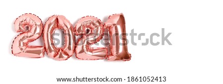 Banner with 2021 made from rose gold color balloons isolated on a white background with copy space. 