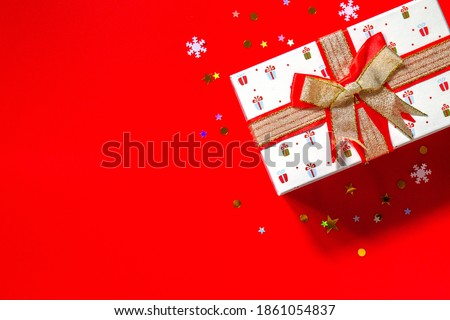 Christmas or New Year concept. Christmas presents gift red on  red background. Flat top view. Copy space.