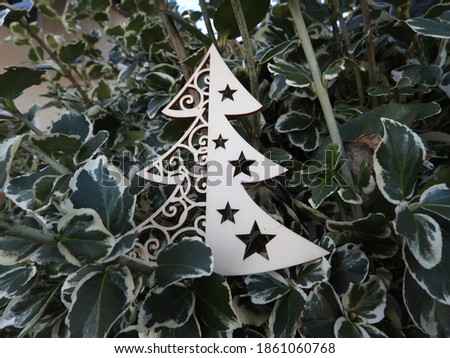 little wooden tree with green and white leaves as background