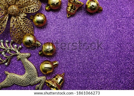 Christmas composition with ellk and Gold Christmas balls with space copy on Purple glitter background