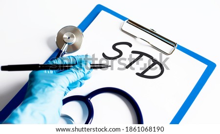 Paper with text STD on a table with stethoscope. Medical concept