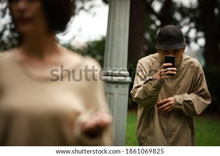 Image of a man voyeuring a woman Royalty-Free Stock Photo #1861069825