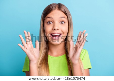 Portrait of young happy cheerful positive good mood girl hold hands in excitement isolated on blue color background