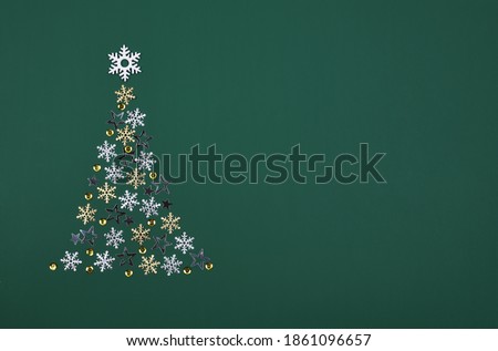 Christmas tree with silver and golden snowflakes on green background