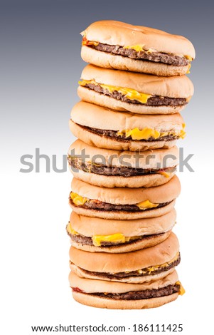 a very tall pile of cheesburgers representing gluttony or a very special fast food offer