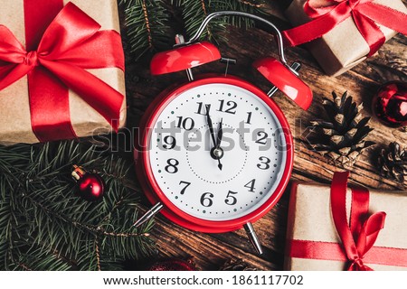 Flat lay composition with Christmas gifts and alarm clock on wooden table. Boxing day