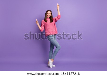 Full length body size photo of cheerful dancing at disco smiling moving woman isolated on vibrant purple color background