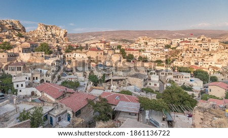 Urgup Town aerial panoramic view from Temenni Hill in Cappadocia Region of Turkey timelapse. Old houses and buildings in rocks at evening before sunset Royalty-Free Stock Photo #1861136722