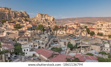 Urgup Town aerial panoramic view from Temenni Hill in Cappadocia Region of Turkey timelapse. Old houses and buildings in rocks at evening before sunset Royalty-Free Stock Photo #1861136794