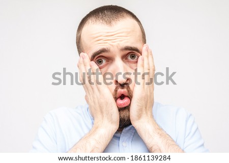 Man is very upset and puzzled, grimace of frustration on the face bearded man, close-up Royalty-Free Stock Photo #1861139284