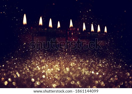 Abstract image of jewish holiday Hanukkah background with menorah (traditional candelabra) and candles. glitter overlay
