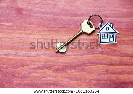 Personal Home Concept. House Symbol Token Along With Golden Key Over Vintage Background. Horizontal Orientation