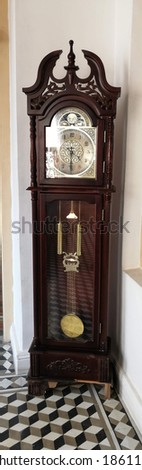 Wooden brown standing clock on white background.