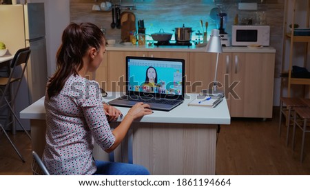 Professional woman photo retoucher working on a big project in home office at night time. Content creator doing portrait retouching using performance laptop, artist, occupation, screen, graphic