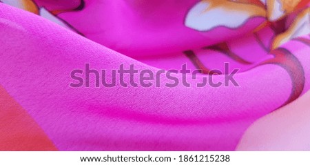 Pink, semi-transparent
fabric with a floral print of orchids; in the folds (texture).