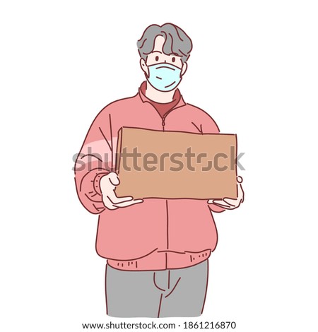Delivery man wearing medical mask holding box.
